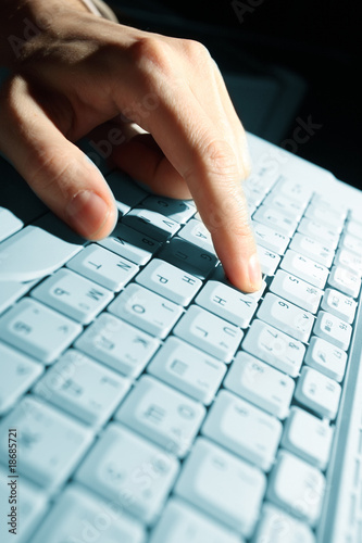 male hands typing on a laptop