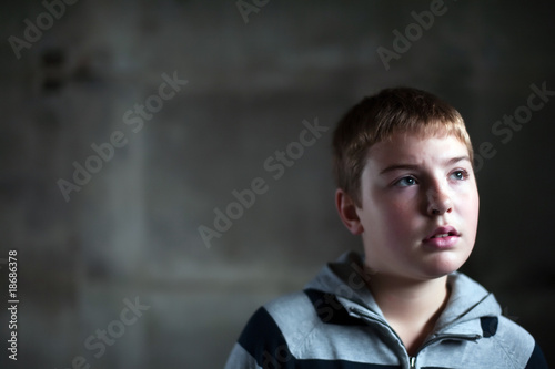 Young boy looking up with hope in his eyes