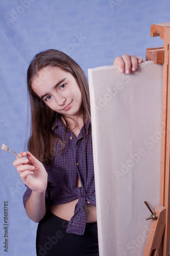 Little painter lloking behid easel photo