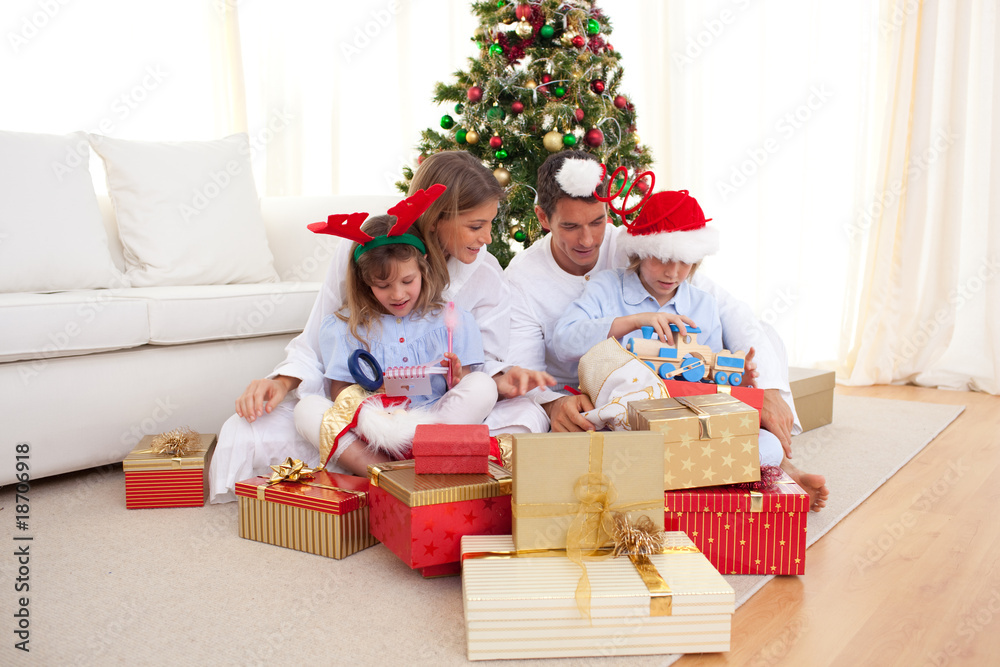 Young family unpacking Christmas presents