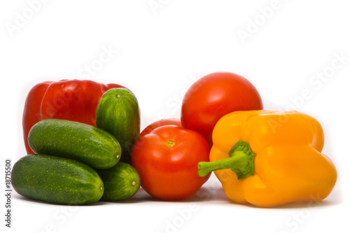 Fresh tomatoes, cucumbers and pepper on a studio white backgroun