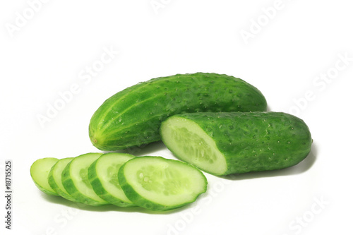 green cucumber chopped circles lying on a white plate