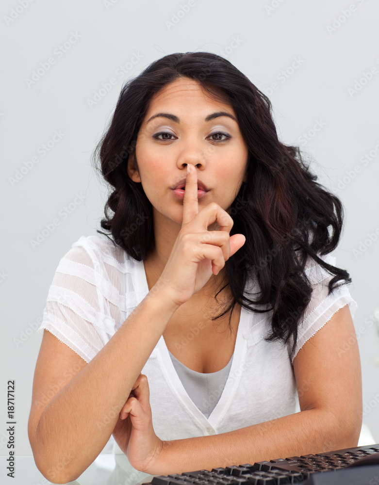 Ethnic businesswoman asking for silence in the office Ethnic businesswoman asking for silence in the office
