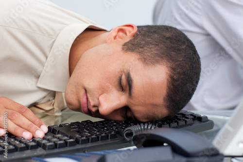 Young businessman sleeping on the laptop