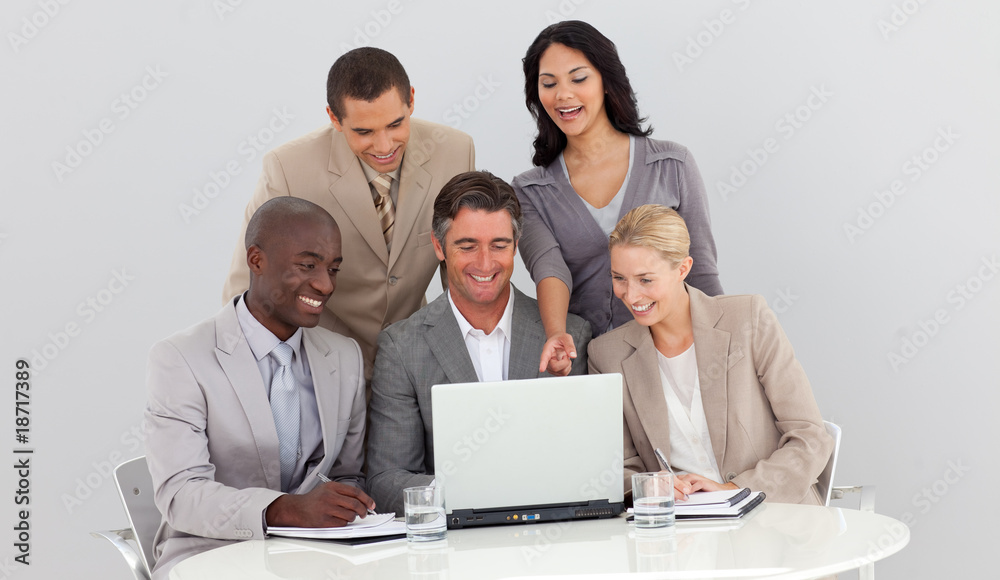 Multi-ethnic business team studying sales figures Multi-ethnic business team studying sales figures