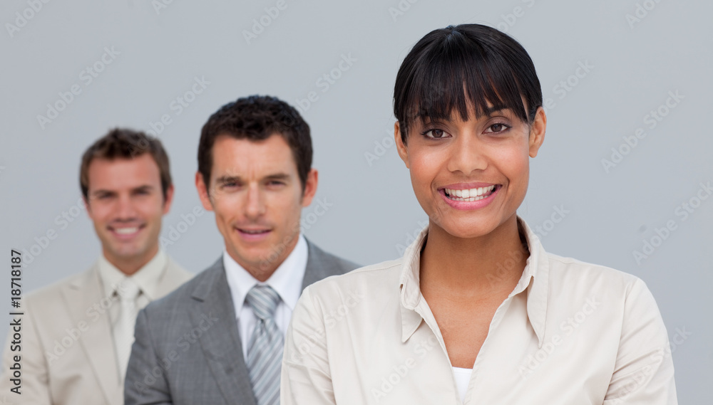 Afro-American businesswoman smiling at the camera with her colle Afro-American businesswoman smiling at the camera with her colle