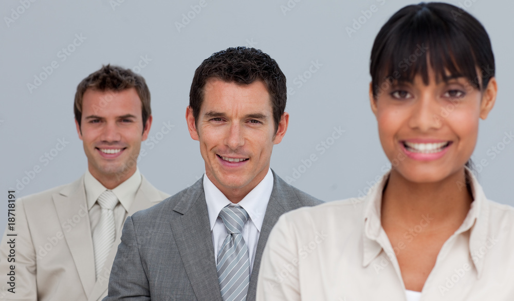 Two businessmen and a businesswoman smiling at the camera Two businessmen and a businesswoman smiling at the camera