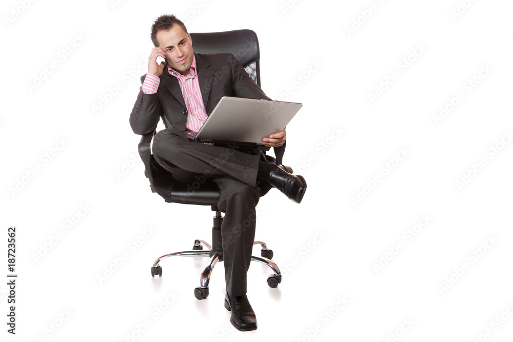 Relaxed young businessman, sitting on a chair.