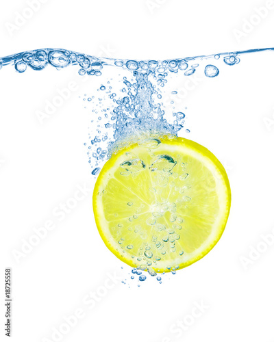 Lemon slice in water with bubbles