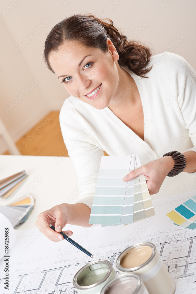 Young female interior designer working at office