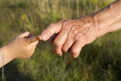 hand of grandmother and grandchild