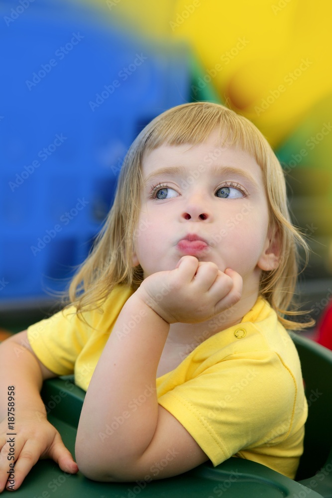 Blond little girl funny expression in her mouth Blond little girl funny expression in her mouth