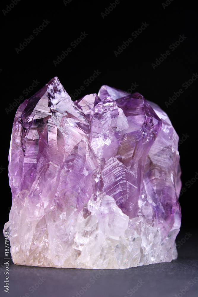 Crystals of magenta amethyst shined on a dark background Crystals of magenta amethyst shined on a dark background