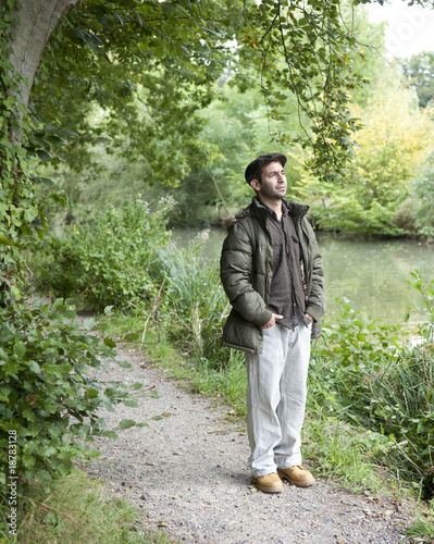 Man standing on a canal towpath