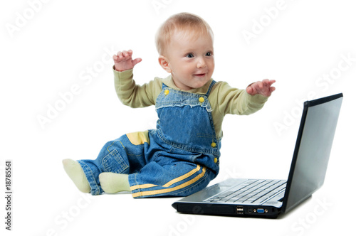 The small smiling happy kid with the laptop