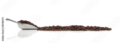 A silver scoop with coffee beans on white