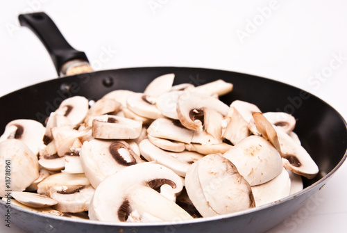 champignon mushrooms cutted to pieces on the frying pan
