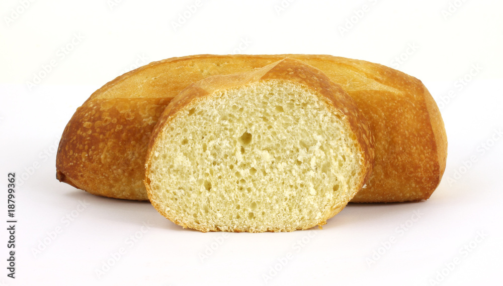 Sourdough bread loaf with single slice in the foreground