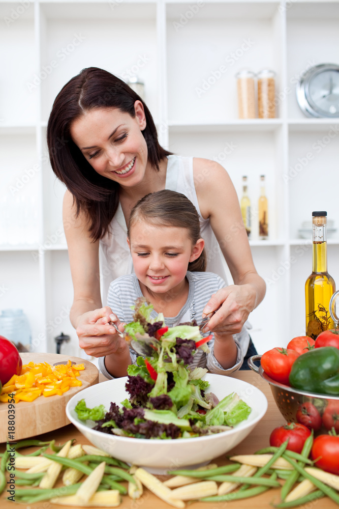 Little girl cooking with her mother