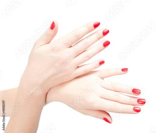 Fingers with red nails on white.