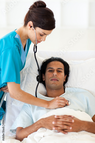 Confident doctor checking the pulse of a patient