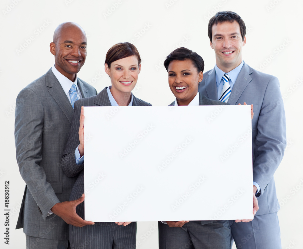 Multi-ethnic business team holding white card Multi-ethnic business team holding white card