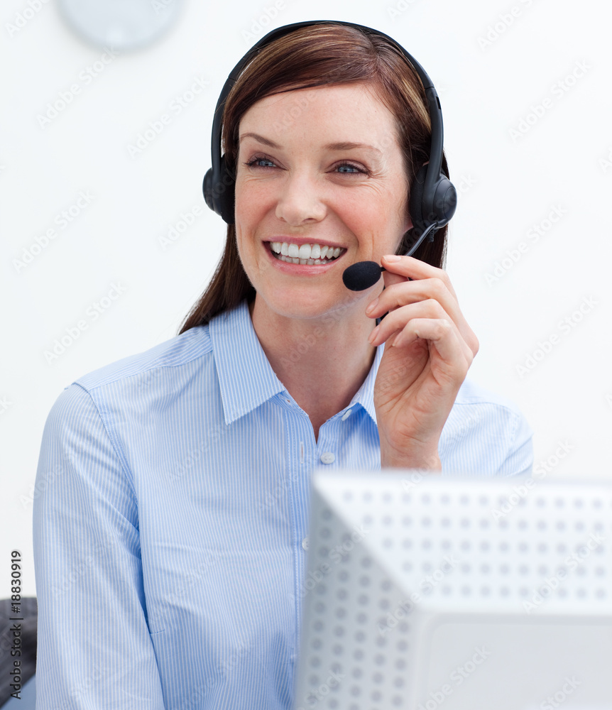 Confident businesswoman with headset on in a call center Confident businesswoman with headset on in a call center