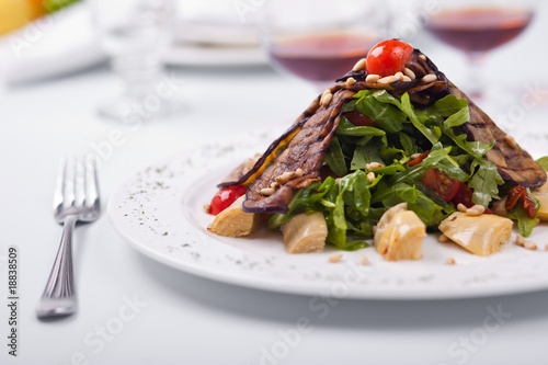 Salad from Eruca sativa, eggplants and tomatoes
