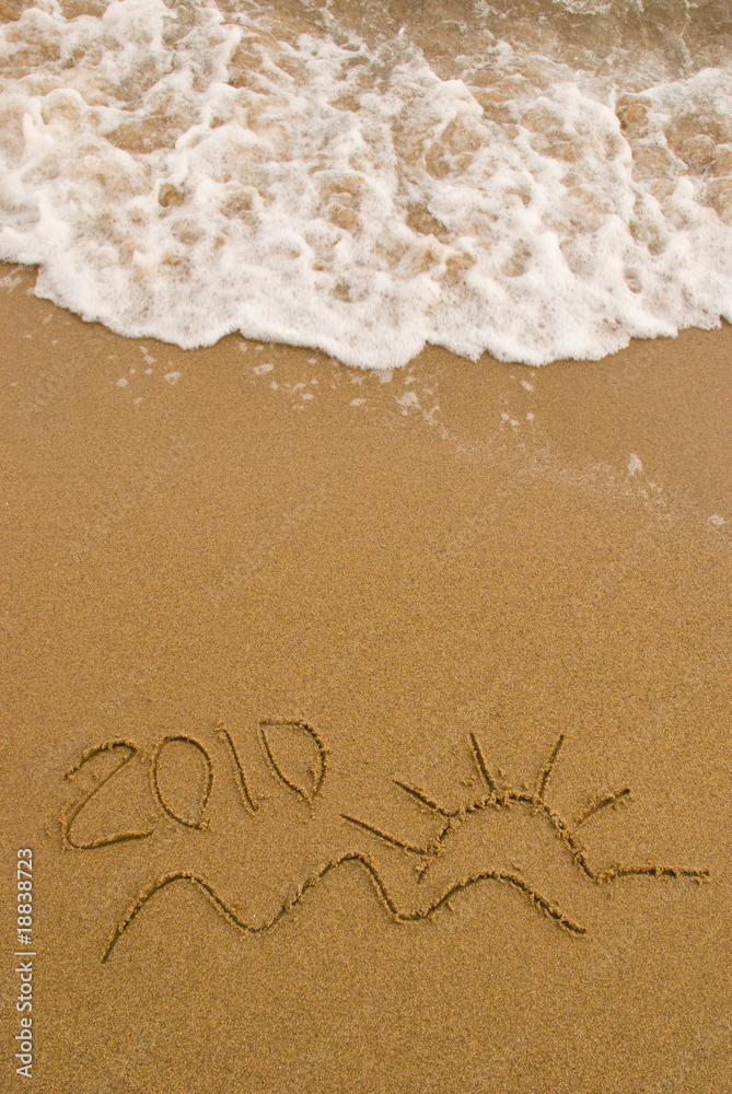 Fototapeta premium Year 2010 written on the sand