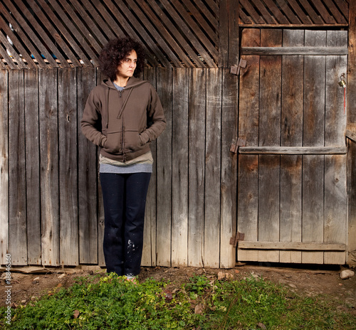 Woman standing near wooden wall
