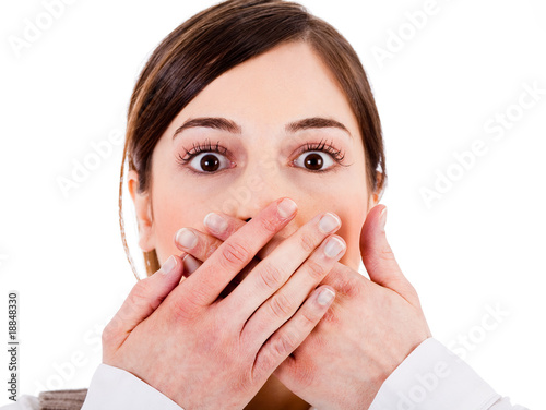 Closeup of young women covering her mouth with both hands