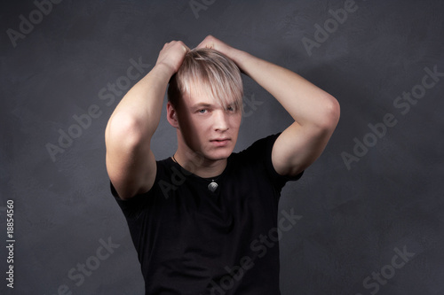 young blond guy with a gray background