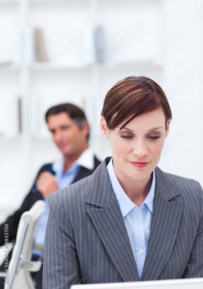 Portrait of a confident businesswoman sitting at office desk Portrait of a confident businesswoman sitting at office desk