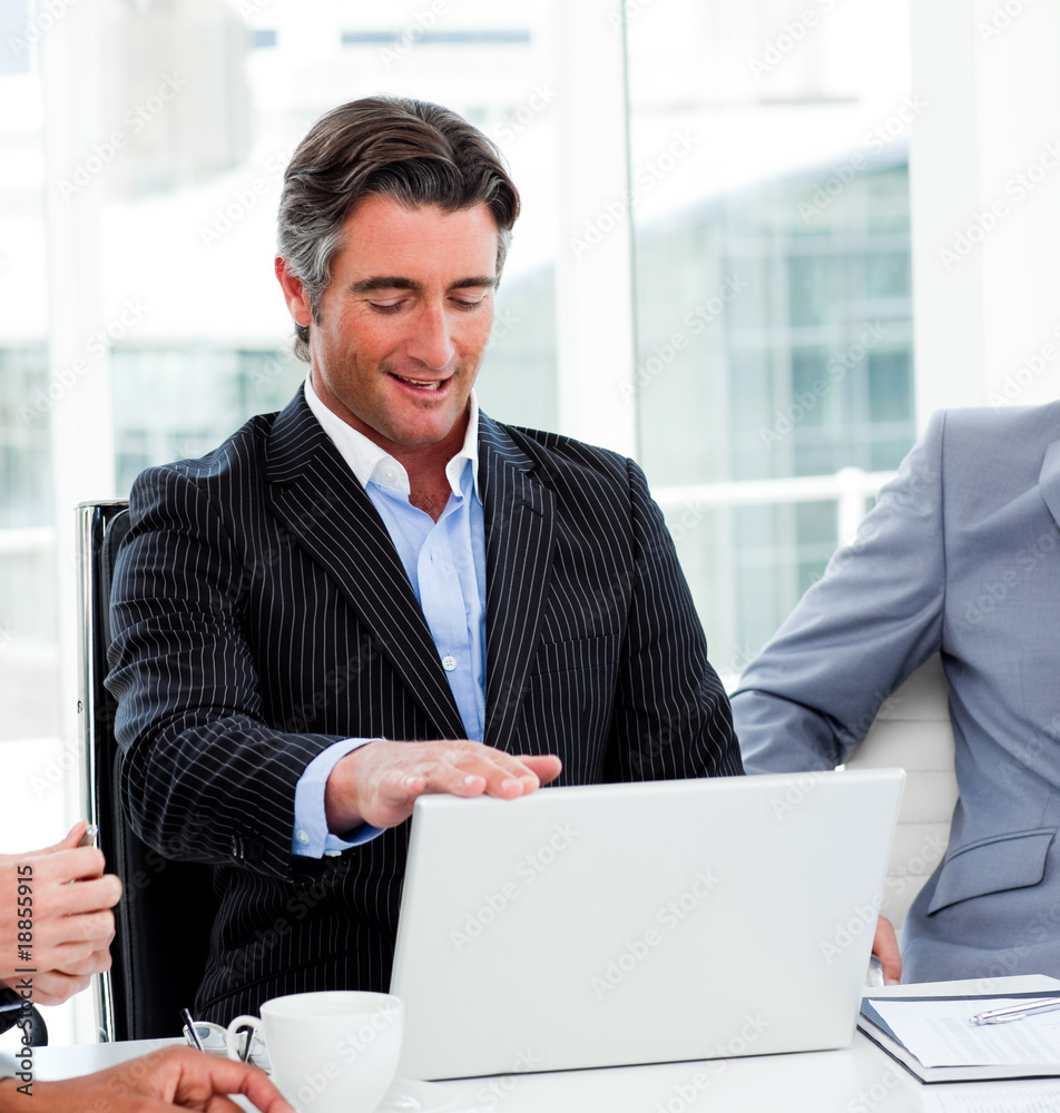 Fototapeta premium Portrait of a confident businessman using a laptop