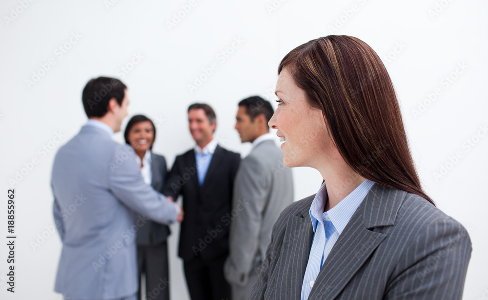 Attractive female executive looking at her team Attractive female executive looking at her team