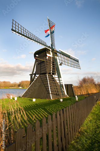 Windmill in dutch landscape photo