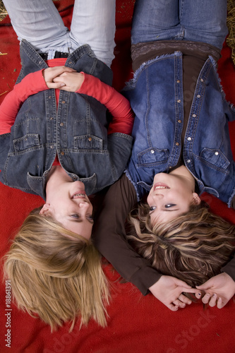 girls on blanket top view smiling