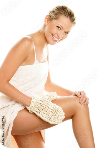 Woman massaging her thigh with sisal glove
