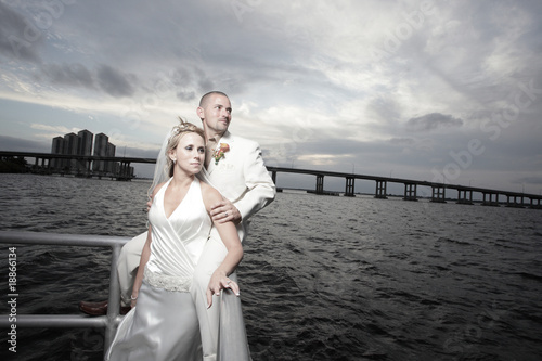 Young groom and bride posing by the bay