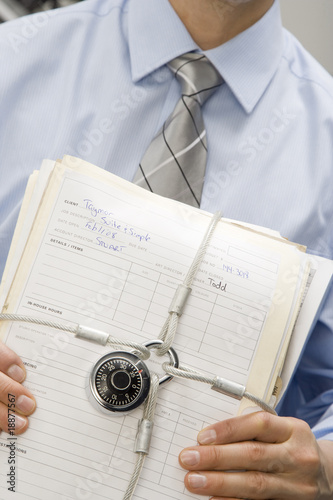 Businessman Holding Locked File Folders