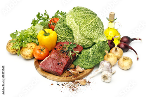 Fototapeta Naklejka Na Ścianę i Meble -  raw fresh meat on board with vegetables on white background