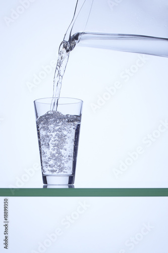 Wallpaper Mural Pouring water into a glass using a carafe Torontodigital.ca