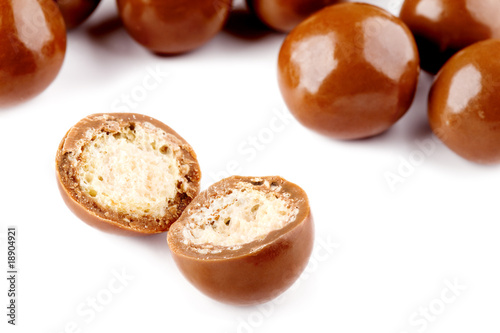 Chocolate balls and half with crisp filling isolated on white