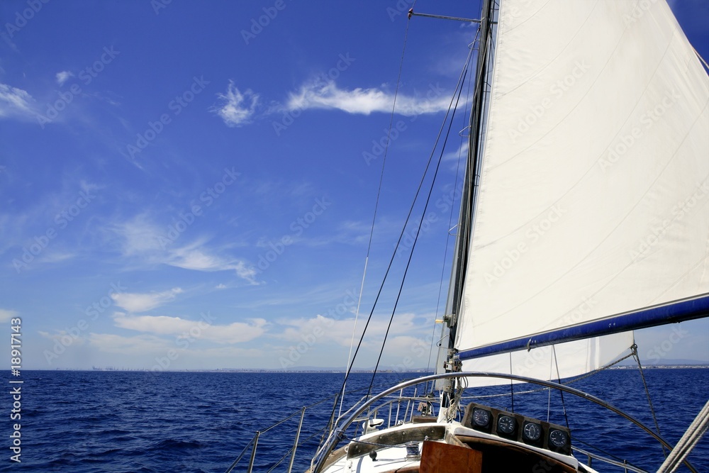 Sailboat sailing blue sea on sunny summer day Sailboat sailing blue sea on sunny summer day