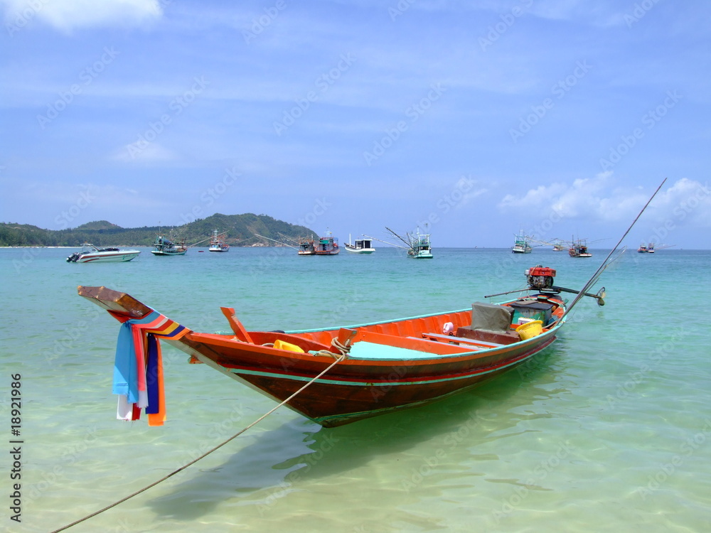 Boat on a calm sea shore, Koh Phangan, Thailand.