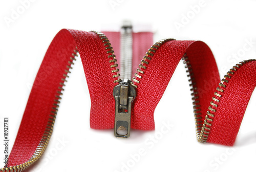 Red zipper on a white background with metal teeths; photo