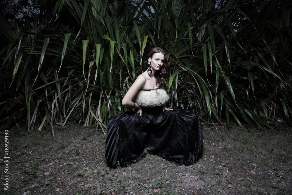 Fototapeta premium Beautiful model posing in a field at night