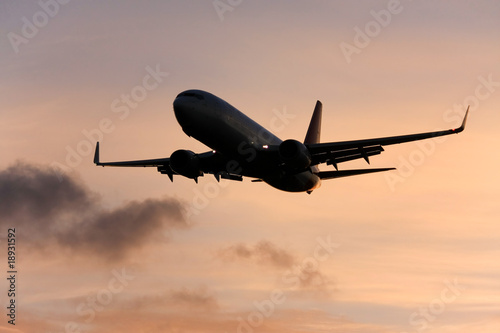 Airliner silhouette, in flight at sunset.