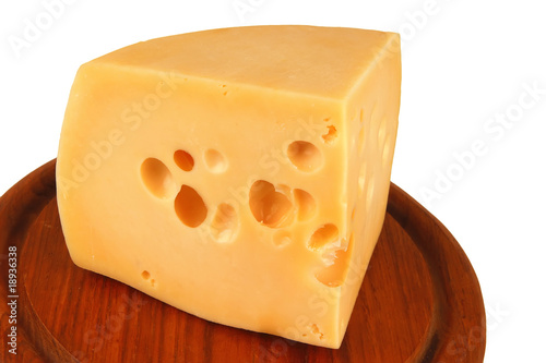 big chunk of yellow cheese on wood plate