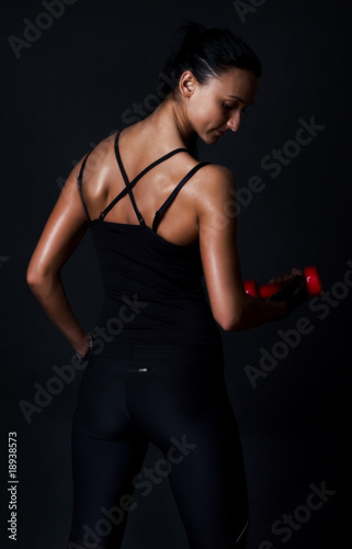 Muscular athlete holding weights
